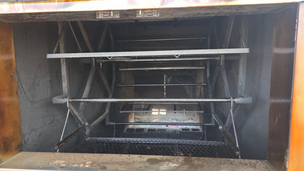 Interior of the hand-built rotisserie barbecue pit at Pure Country BBQ in Pleasanton Texas