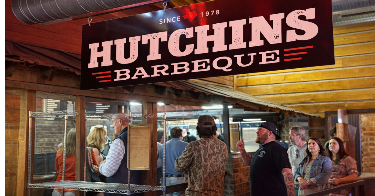 Hutchins BBQ sign hanging inside the dining area in McKinney, Texas