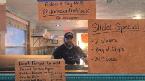 Texas BBQ ordering counter graphic with pit slicer, handwritten signs, slider special, and etiquette reminders to tip your slicer and be polite